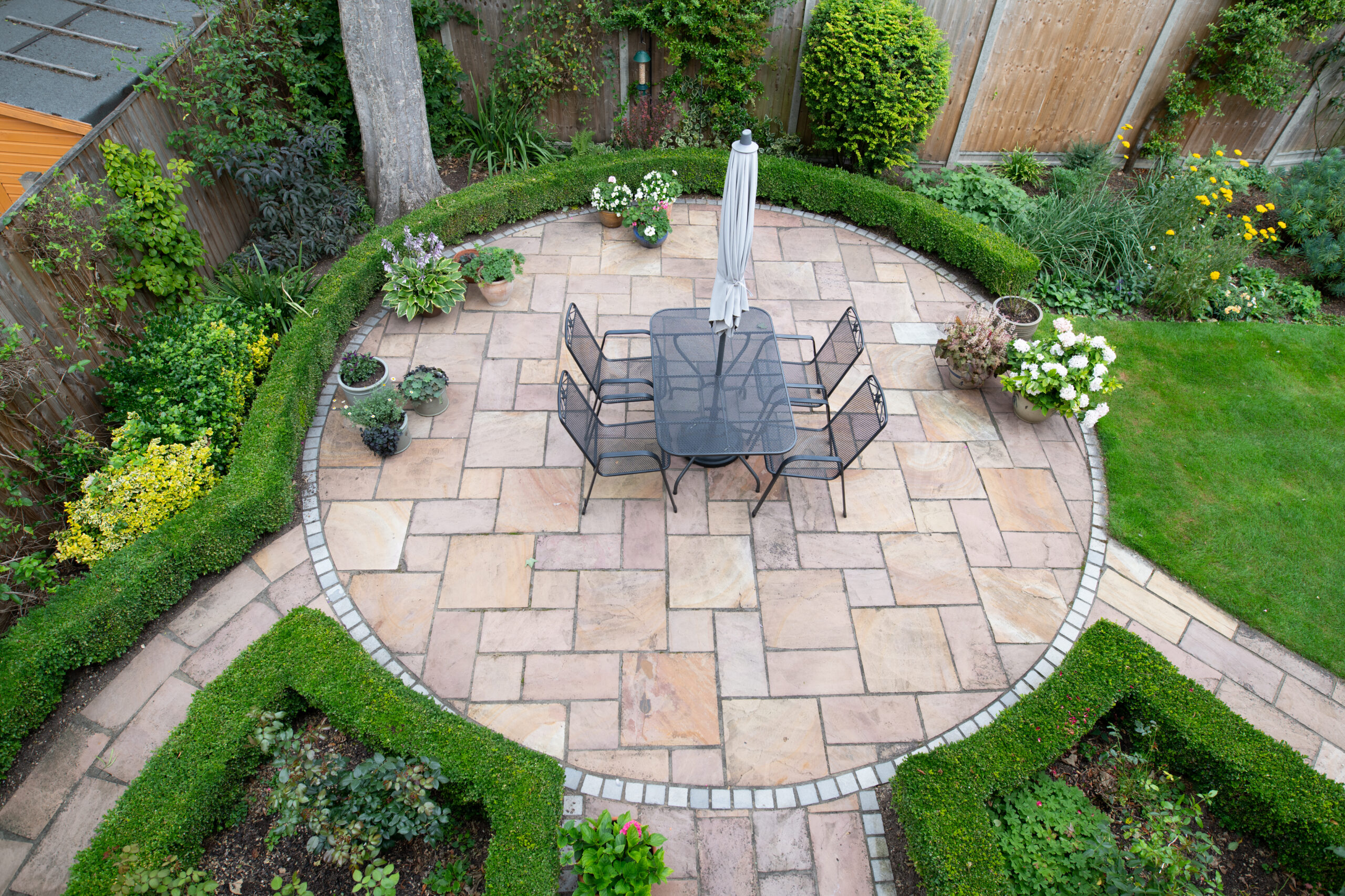 circular garden patio with freshly jet washed paving stones